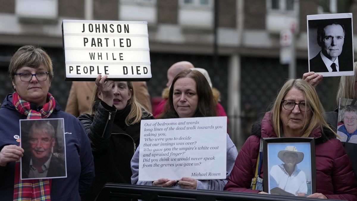 Protesters show pictures of COVID victims and placards outside Dorland House as former PM Boris Johnson testifies at Britain