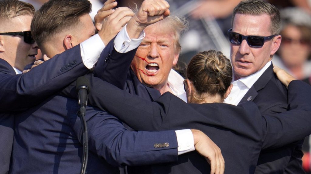 Republican presidential candidate former President Donald Trump is helped off the stage by U.S. Secret Service agents at a campaign event in Butler