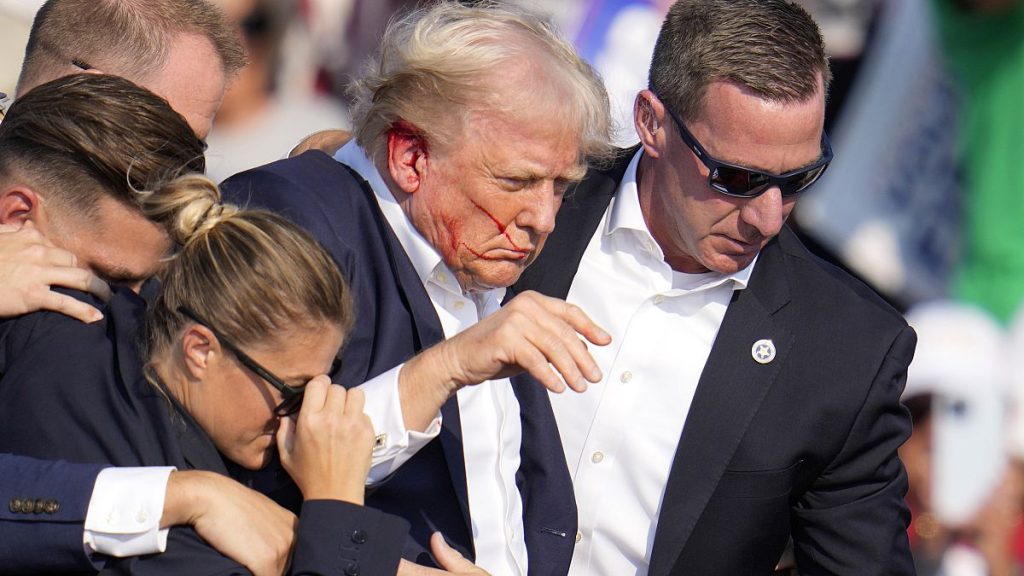 Donald Trump is surrounded by US Secret Service agents at a campaign rally following an assassination attempt