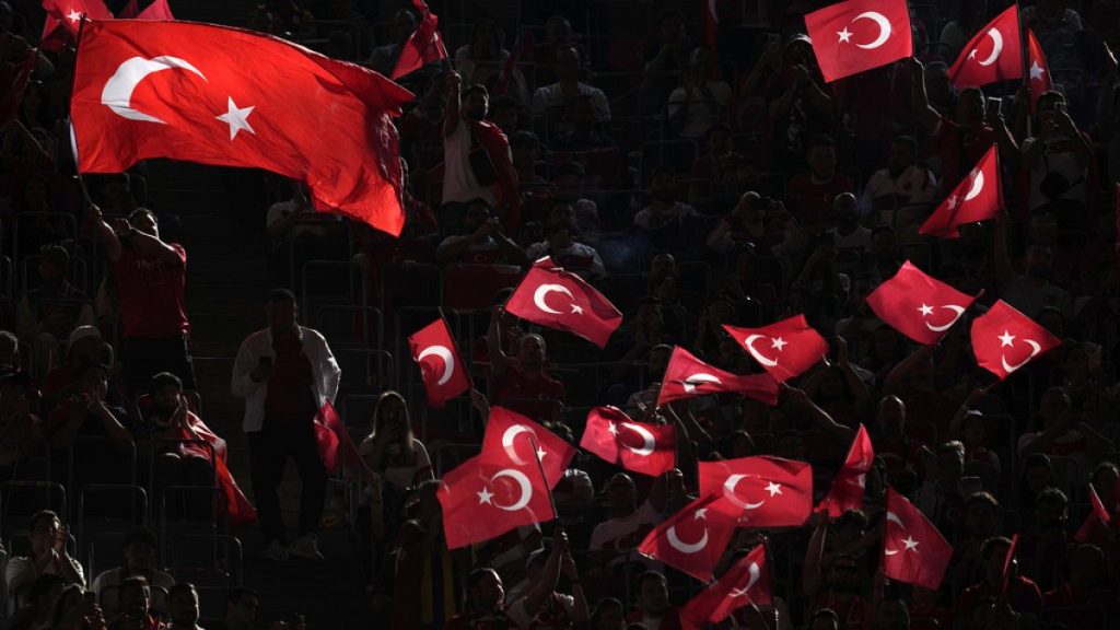 Turkey fans cheer and wave flags before a Group F match between Turkey and Portugal at the Euro 2024 soccer tournament in Dortmund, Germany, Saturday, June 22, 2024. (AP Photo