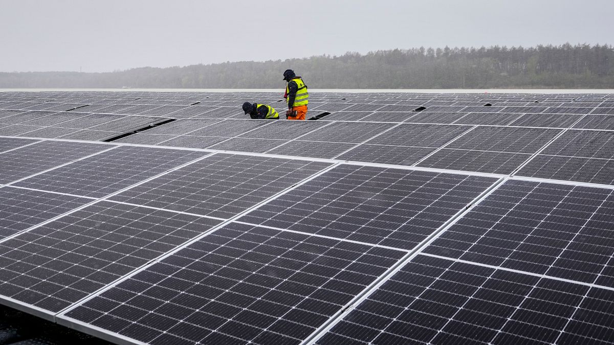 Solar panels are installed at a floating photovoltaic plant on a lake in Haltern, Germany.