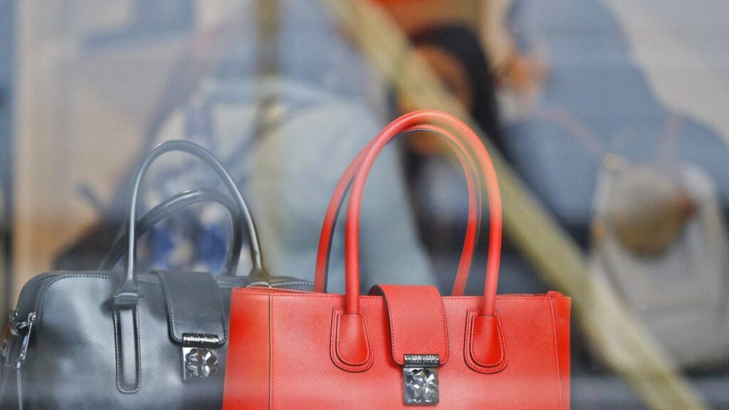 Women shop for bags in a luxurious outlet mall in London, Friday, Oct. 21, 2016.