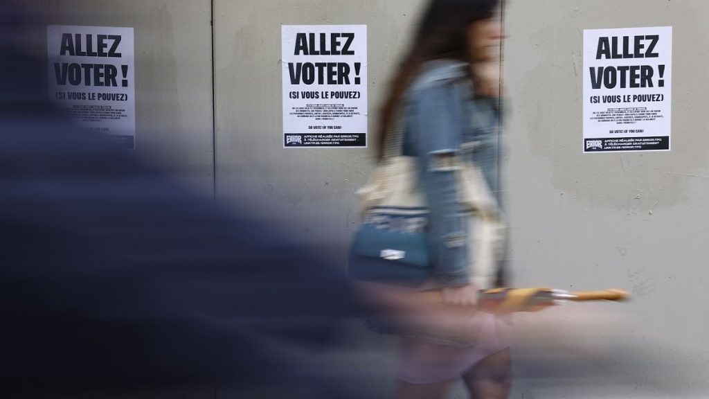 A woman walks past poster reading