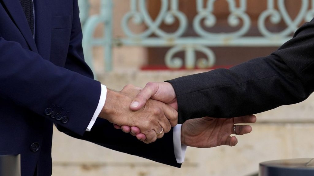 German Chancellor Olaf Scholz and French President Emmanuel Macron shake hands during a press conference in Meseberg, 28 May 2024, File, Closeup