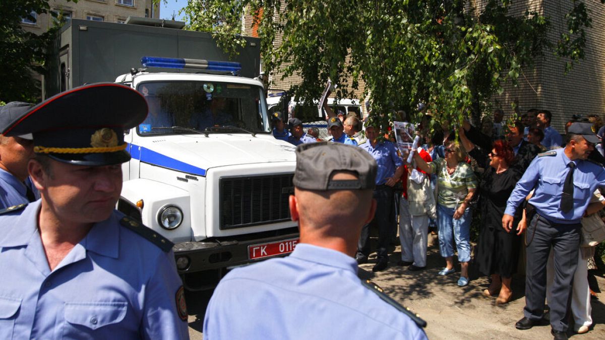 FILE - Police officers outside the court building in the town of Grodno, Belarus, Tuesday, June 14, 2011.