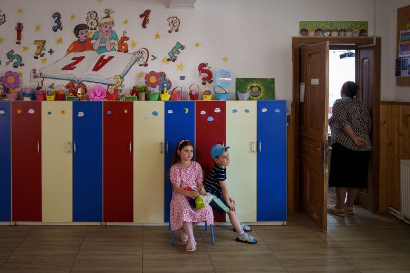 Des enfants attendent que leurs proches votent au Parlement européen et aux élections locales à Baleni, le 9 juin 2024