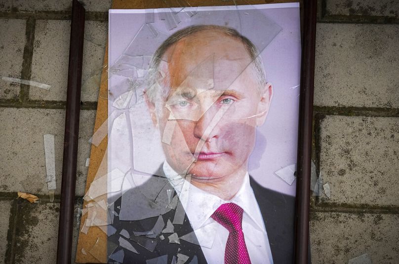 Un portrait du président russe Vladimir Poutine repose sur le sol près de la prison locale de Kherson, le 16 novembre 2022