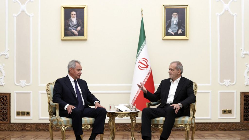 President Masoud Pezeshkian (right) speaks with secretary of Russia