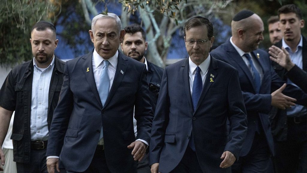 Israeli Prime Minister Benjamin Netanyahu, left, walks with President Isaac Herzog at the state memorial for Ze