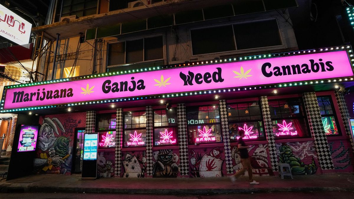 A pedestrian walks past a cannabis shop in Bangkok, Thailand, 15 May 2024.