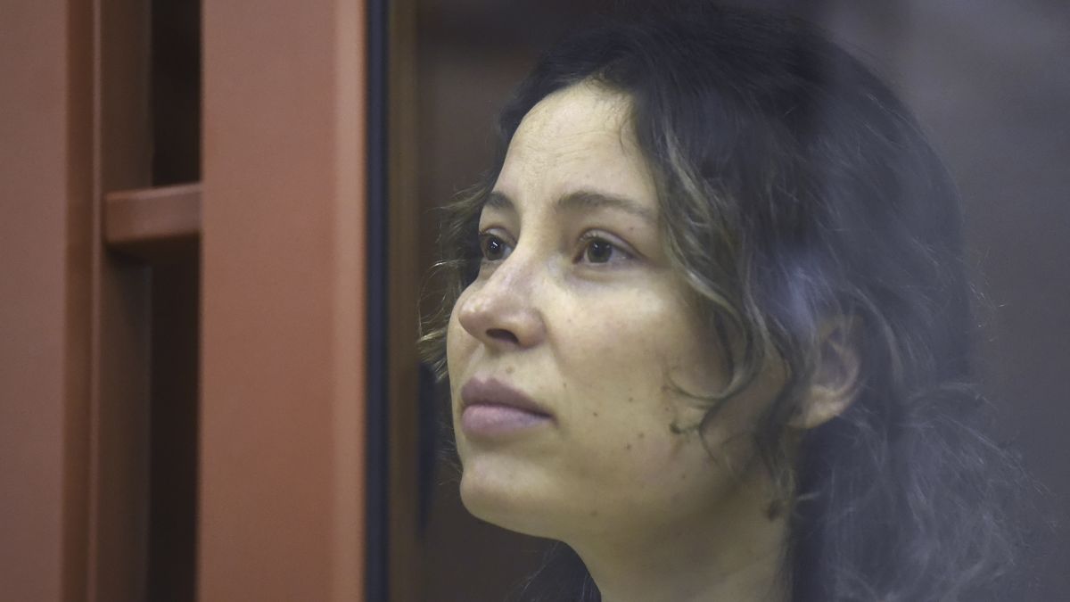 Ksenia Khavana sits in a glass cage in a court room in Yekaterinburg, Russia.