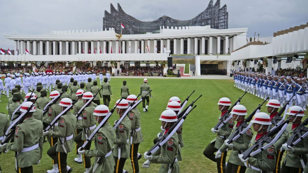 Soldiers march before the start of a ceremony marking Indonesia