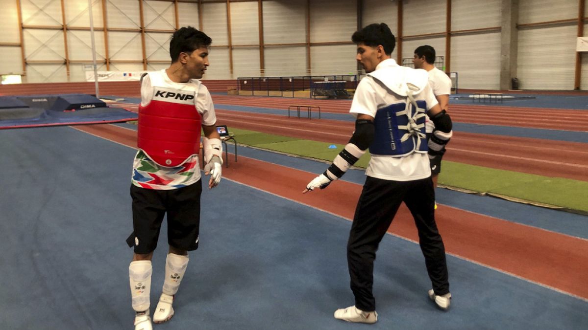 Member of the Refugee Paralympic Team Hadi Hassanzada, left, who will compete in Para taekwondo, trains ahead of the Paralympic Games, Monday, Aug. 19, 2024