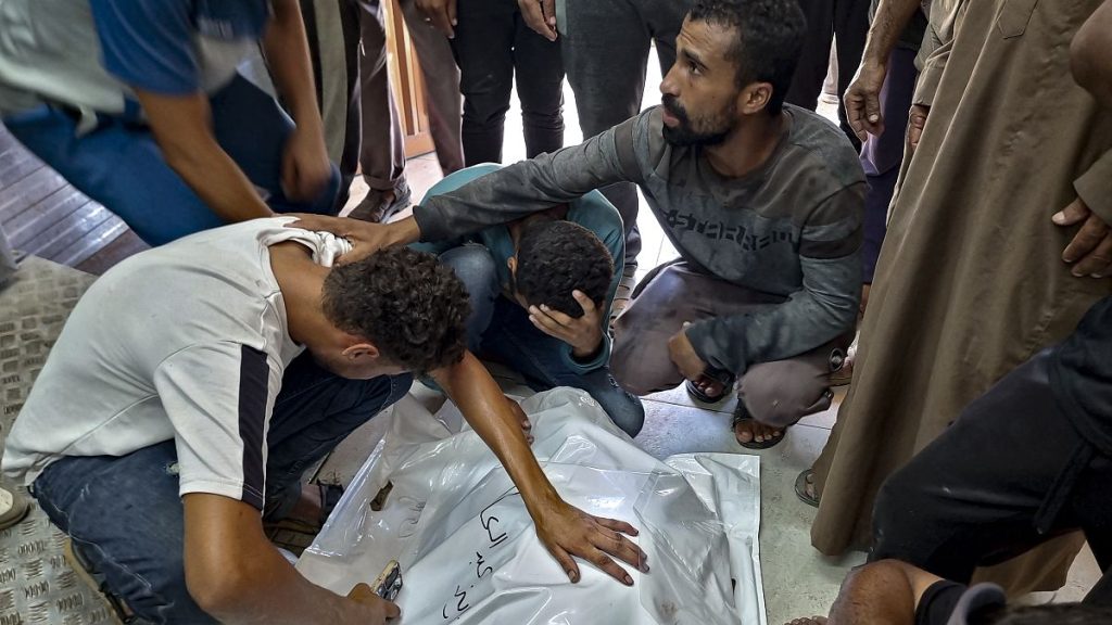 Palestinians mourn a relative killed in the Israeli bombardment of the Gaza Strip, at a hospital in Khan Younis, Saturday, Aug. 24, 2024.