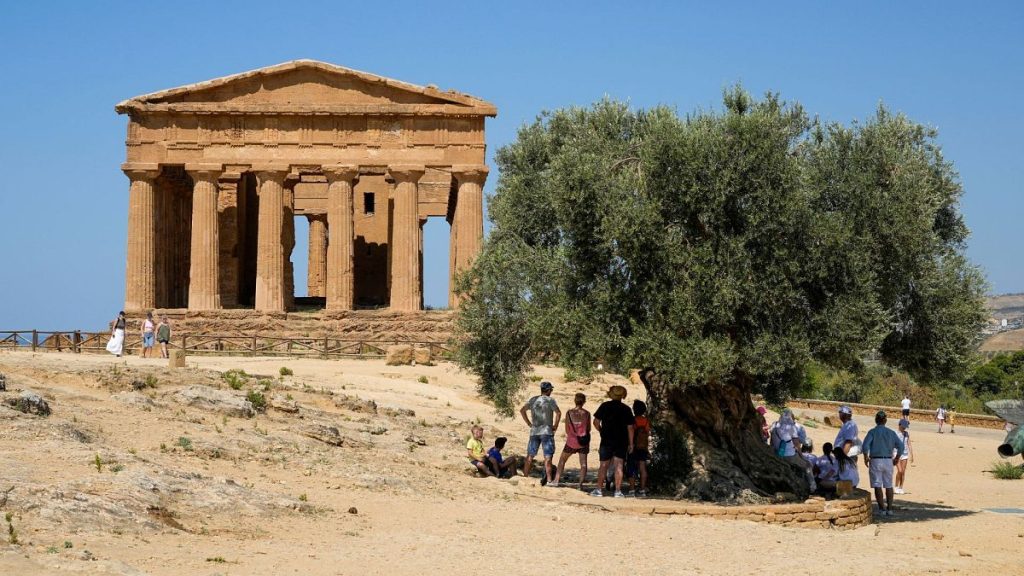 Visitors admire the ancient Concordia temple in the Valley of the Temples, Agrigento, Sicily, Italy, on Thursday, 18 July 2024.