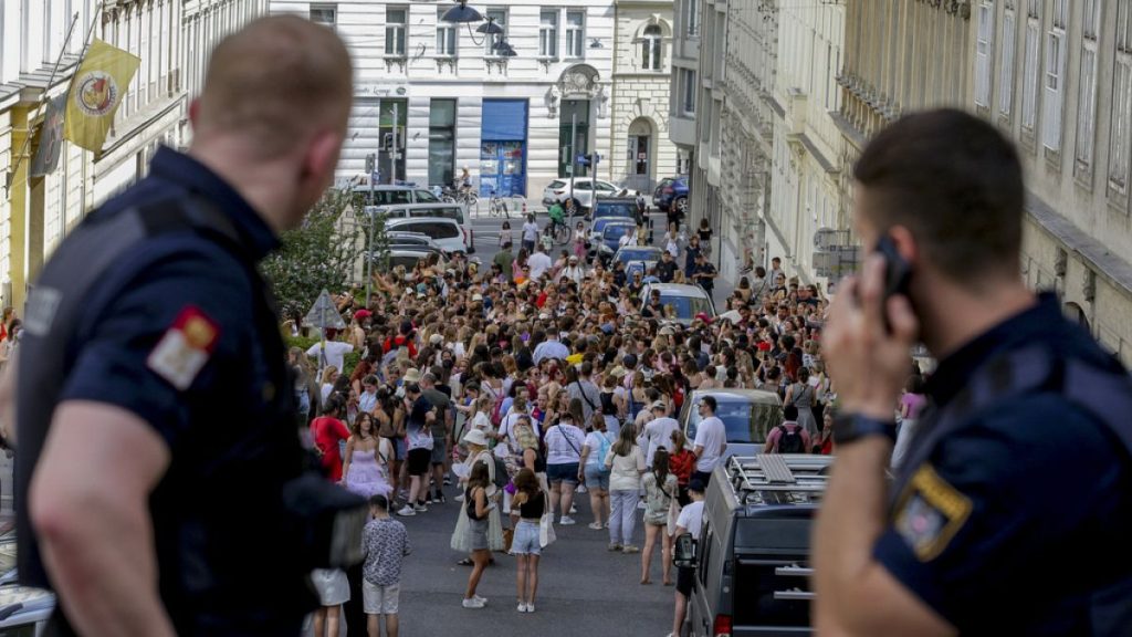 Austrian police officers watch swifts gathering in the city centre in Vienna on Thursday, Aug.8, 2024.