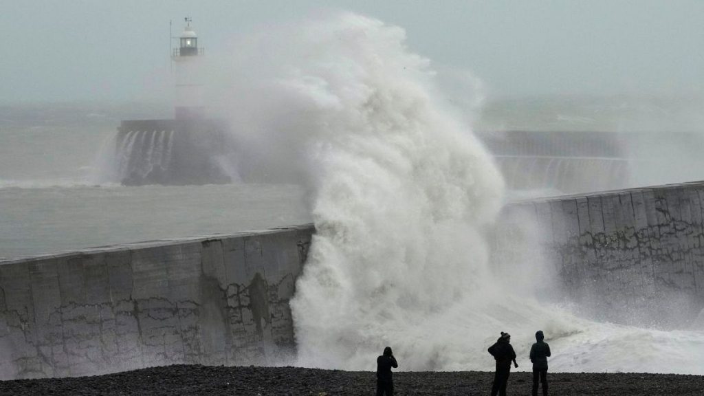 Waves crash over Newhaven Lighthouse and the harbour wall in Newhaven, southern England, November 2023, driven by Storm Ciaran.