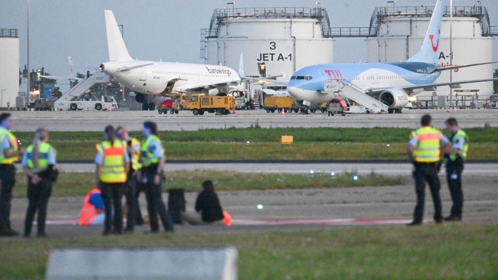 Police on the tarmac at Stuttgart airport, as climate activists staged protests at several German airports on Thursday, 15 August.