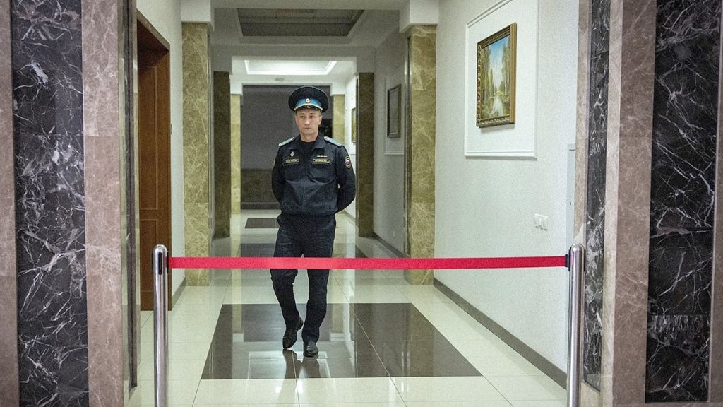 A Russian Federal Bailiffs Service officer guards a corridor leading to a courtroom inside the court in Yekaterinburg, 18 July 2024