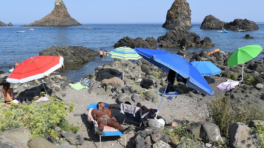 Holidaymakers at the beach in Aci Trezza, near Catania in Sicily