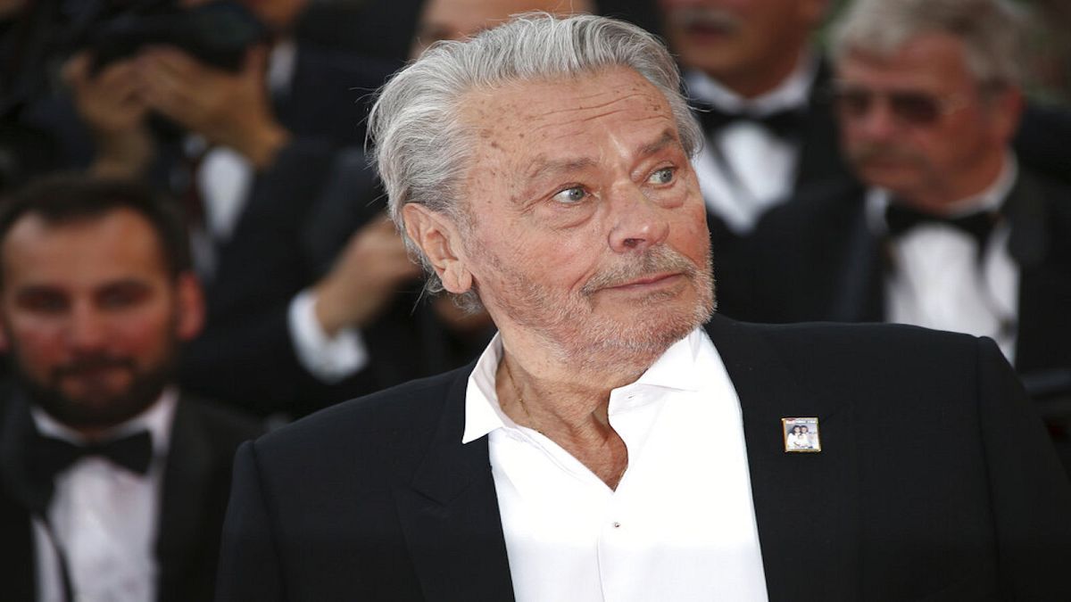 Actor Alain Delon poses for photographers upon arrival at the premiere of the film