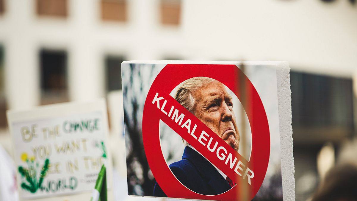 A sign with Donald Trump reading