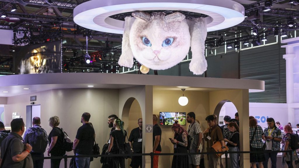 Computer gamers line up at the stand for the game inzoi at the Gamescom computer gaming fair in Cologne, Germany, Wednesday, 21 August 2024.