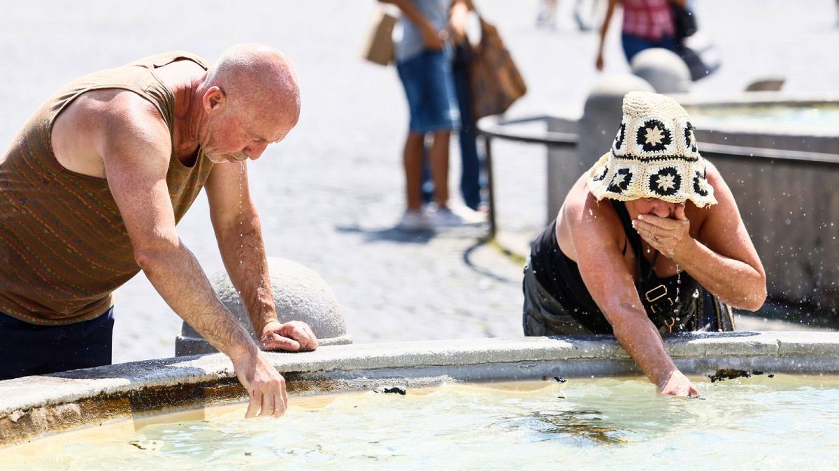 People refresh themselves at a fountain on a hot day in Rome, June 2024. Italy suffered more than 12,000 heat-related deaths last summer.