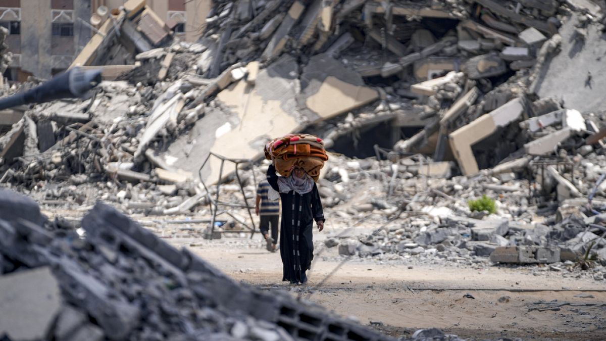 A Palestinian displaced woman flees from Hamad City, following an evacuation order by the Israeli army to leave parts of the southern area of Khan Younis, Sunday, Aug. 11, 202