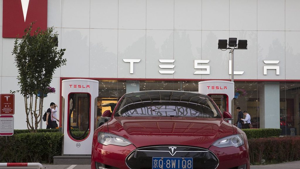 A Tesla vehicle is parked outside a showroom in Beijing, China, Tuesday, May 22, 2018.