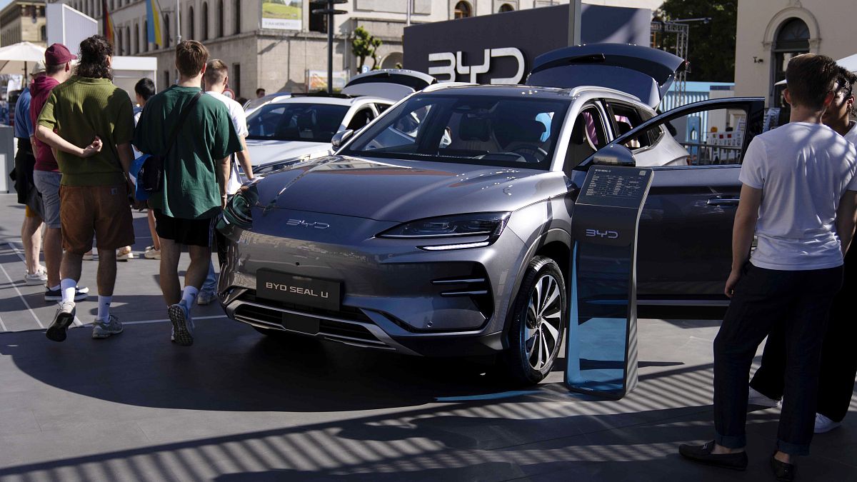 Visitors watch a BYD Seal U car at the IAA motor show in Munich, Germany, Friday, Sept. 8, 2023.