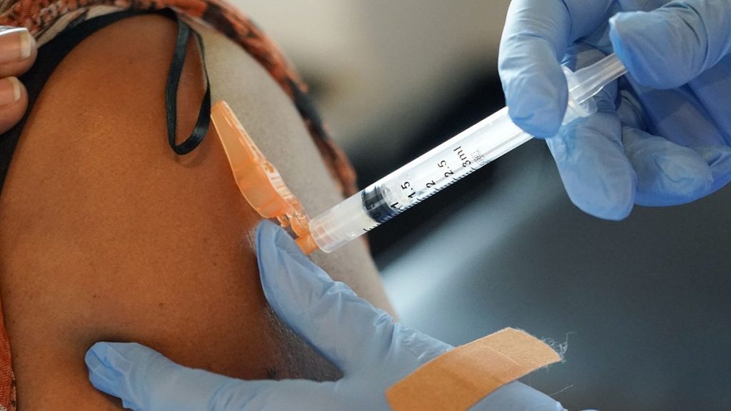 A nurse gives a COVID-19 vaccine to an unidentified person in the US, 2021.