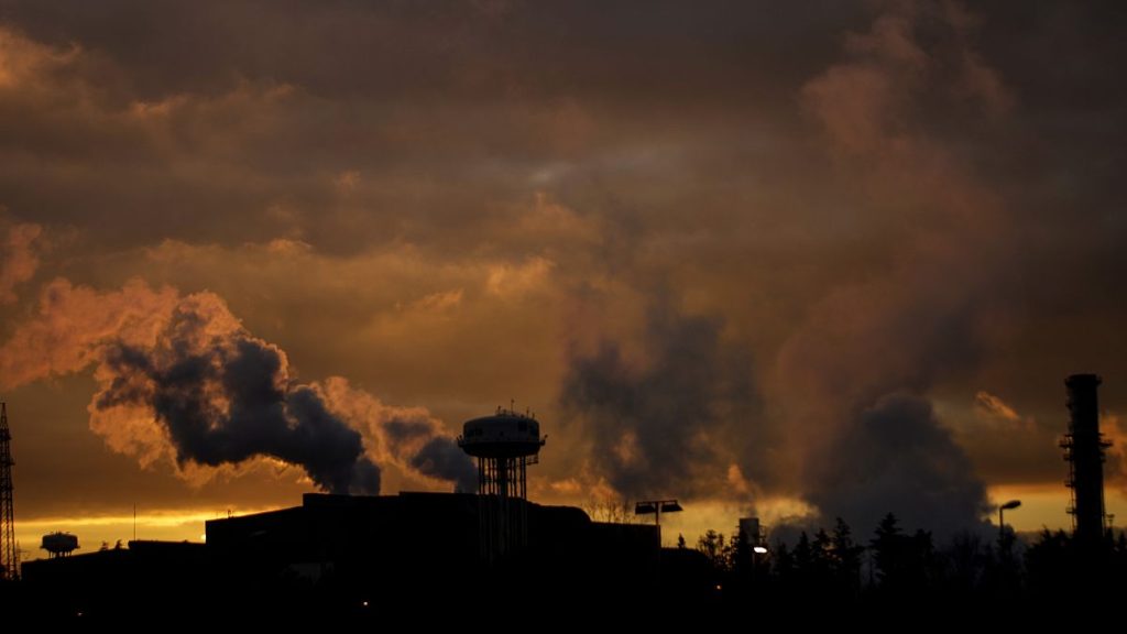 Smoke rises from the chimneys of the Tenaris steel mill factory, in Dalmine, northern Italy, Wednesday, Feb. 10, 2021.