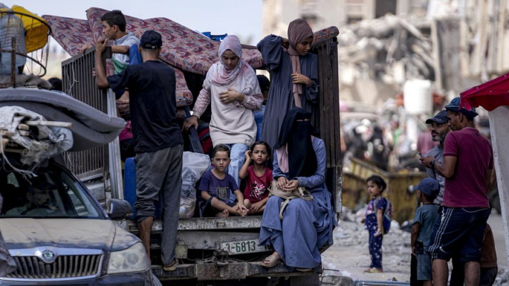 Palestinians displaced by the Israeli air and ground offensive on the Gaza Strip flee from Hamad City, following an evacuation order by the Israeli army to leave parts of the