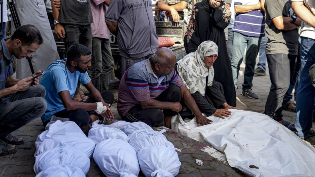 Palestinians mourn for relatives killed in the Israeli bombardment of the Gaza Strip, at a hospital in Deir al-Balah, Saturday, Aug. 10, 2024.