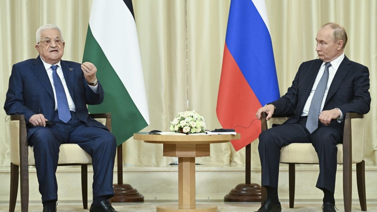 Palestinian President Mahmoud Abbas, left, and Russian President Vladimir Putin walk after their meeting at Novo-Ogaryovo state residence outside Moscow, Russia, Tuesday, Aug.