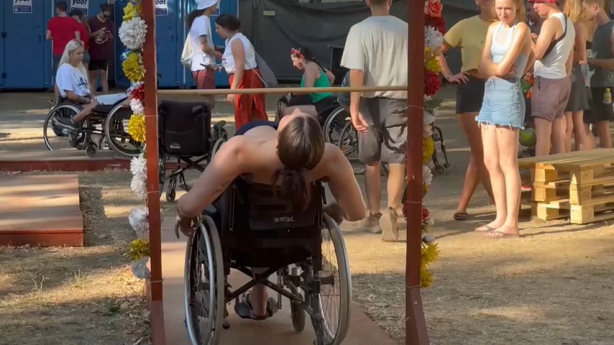 A festival-goer partakes in the wheelchair obstacle course