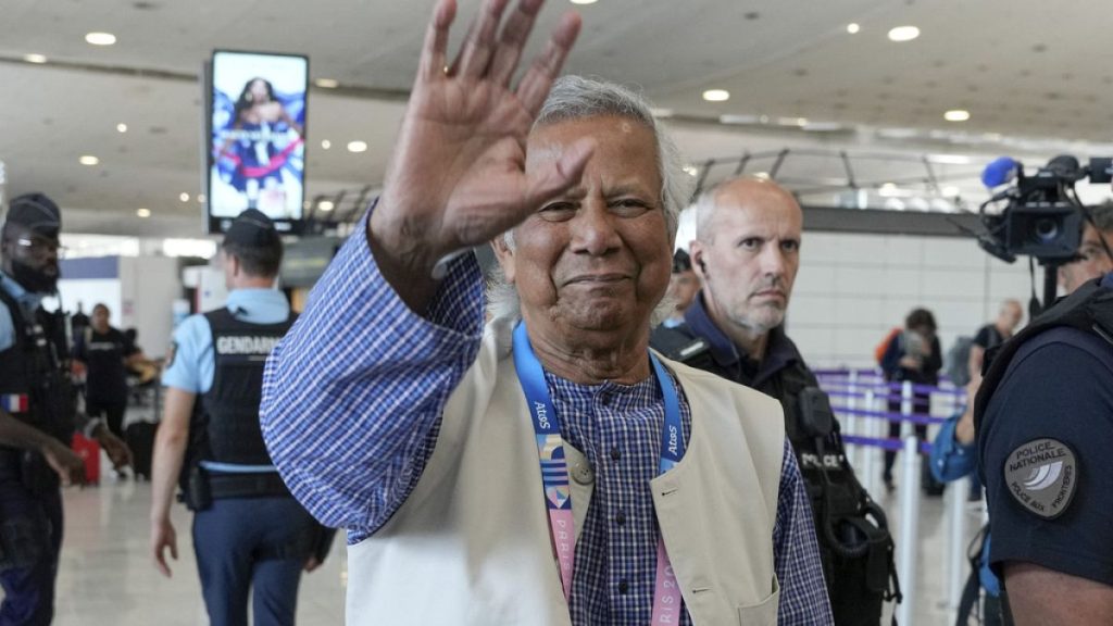 Nobel laureate Muhammad Yunus waves goodbye to the media at Charles de Gaulle