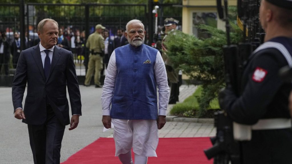 Indian Prime Minister Narendra Modi, right, walks with his Polish counterpart Donald Tusk, to inspect an honour guard before talks in Warsaw, Poland, Thursday, Aug. 22, 2024.