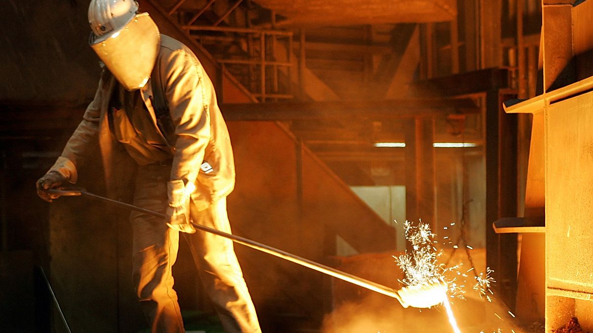 A steelworker takes a sample at the blast furnace of ThyssenKrupp Stahl in Duisburg on September 22, 2005.