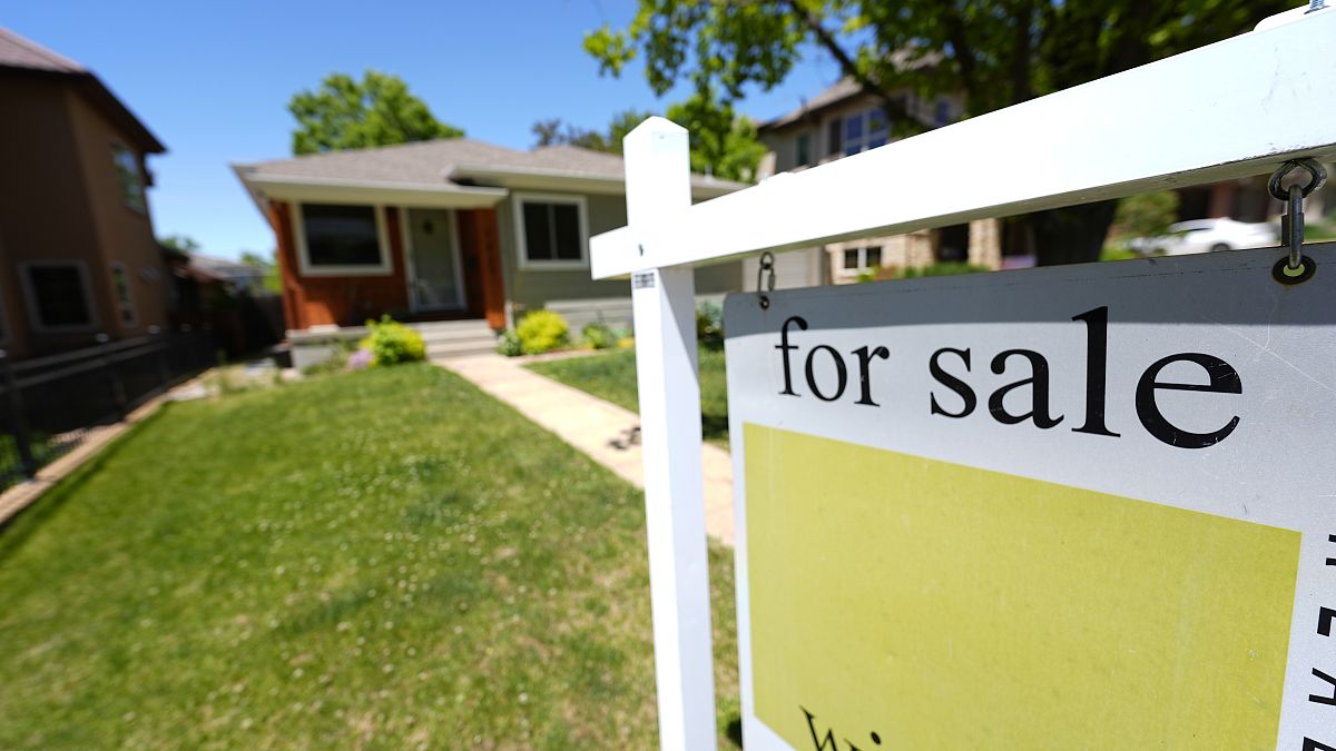 A for sale sign stands outside a single-family residence on Wednesday, May 22, 2024, in southeast Denver.