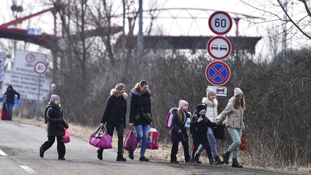 Ukrainian refugees crossing the border into HUngary the day after Russia