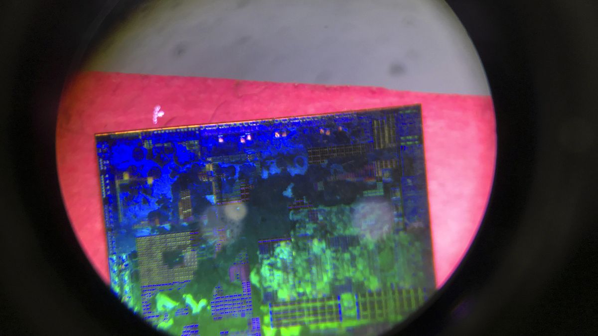 A Chinese microchip is seen through a microscope set up at the Tsinghua Unigroup project booth during the China Beijing International High-tech Expo on May 17, 2018.