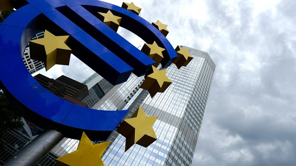 In this June 5, 2014 file picture the Euro sculpture stands in front of the European Central Bank building in Frankfurt, Germany.