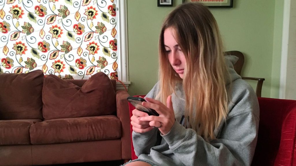 A student holding her phone.