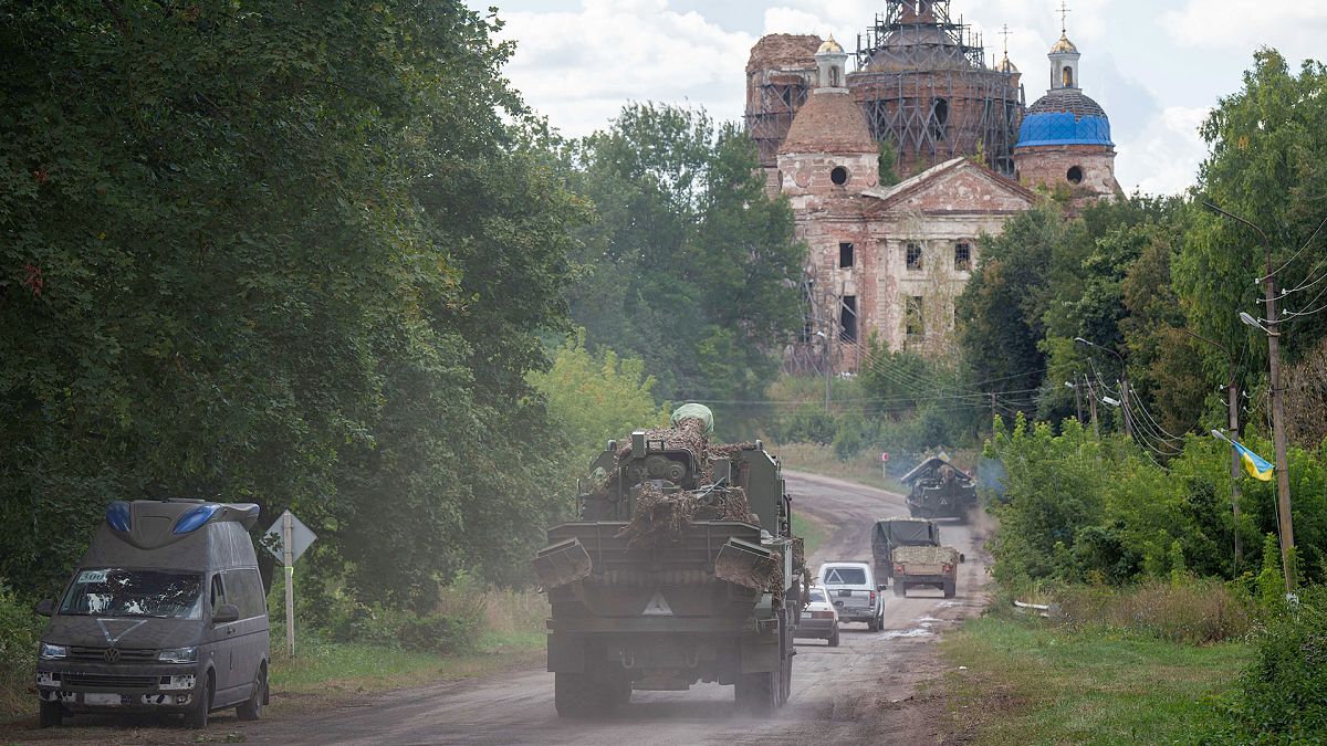 Military vehicles drive near the Russian-Ukrainian border in Sumy region, 13 August 2024