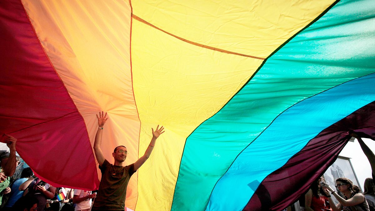 FILE: Young Bulgarian is seen underneath the rainbow flag during the the fourth gay pride rally in the Bulgarian capital of Sofia, 18 June 2011