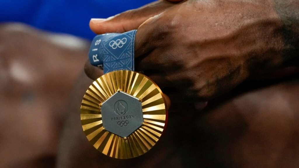 LeBron James holds his gold medal during a women