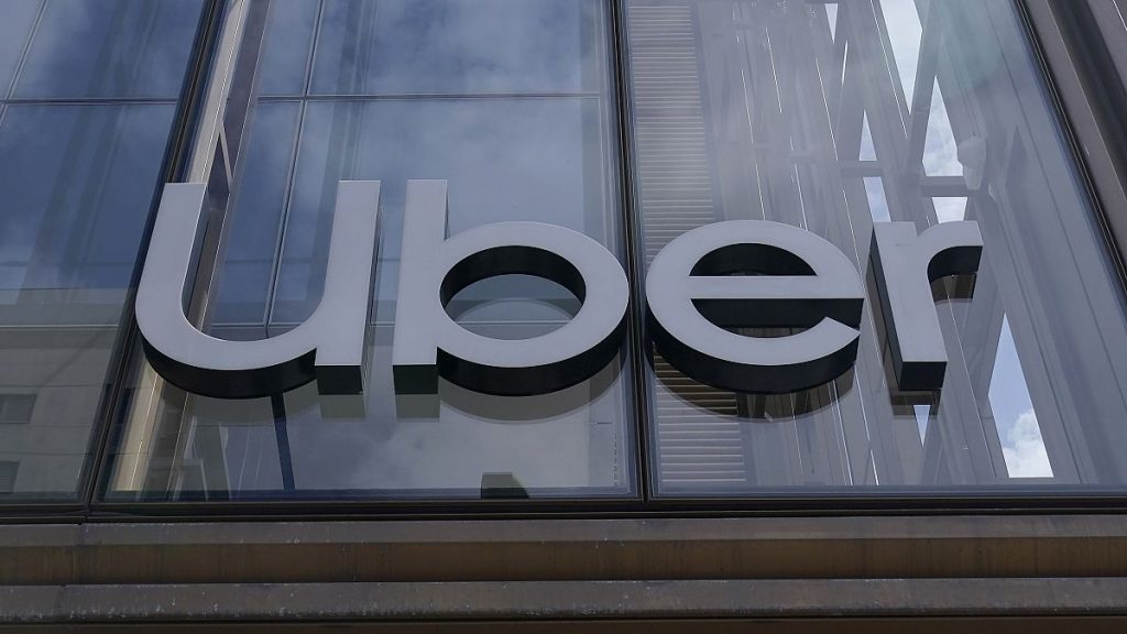 FILE - An Uber sign is displayed at the company