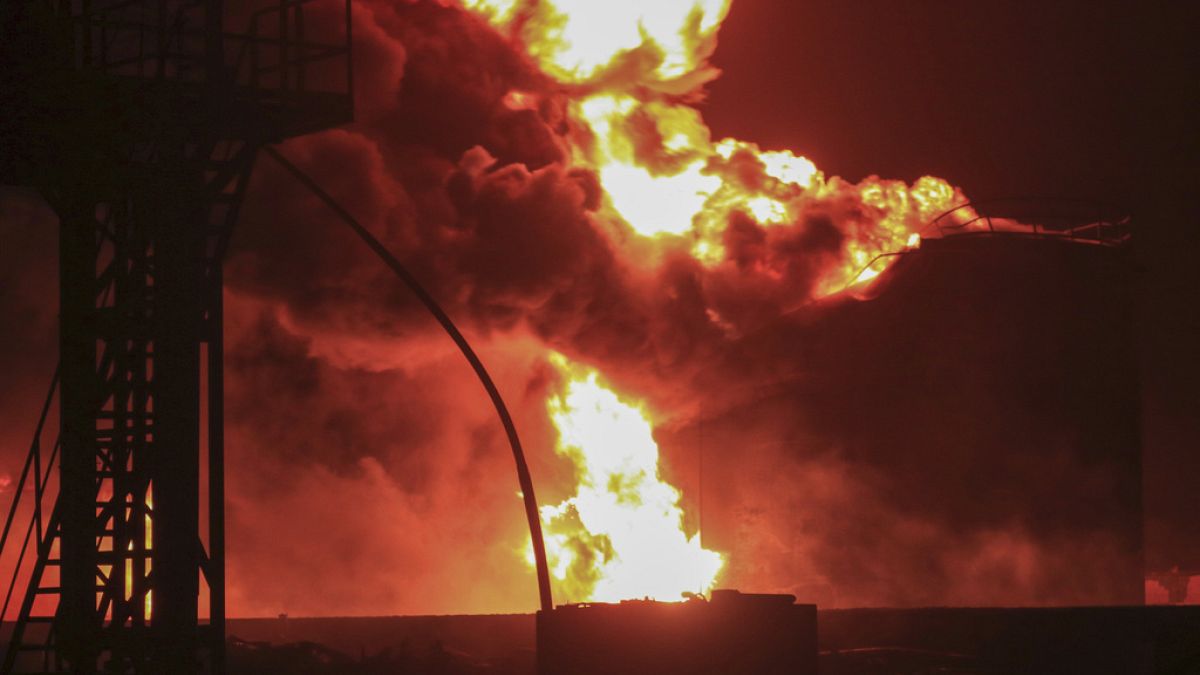 Oil tanks burn at the port in Hodeidah, Yemen, Saturday, July 20, 2024.